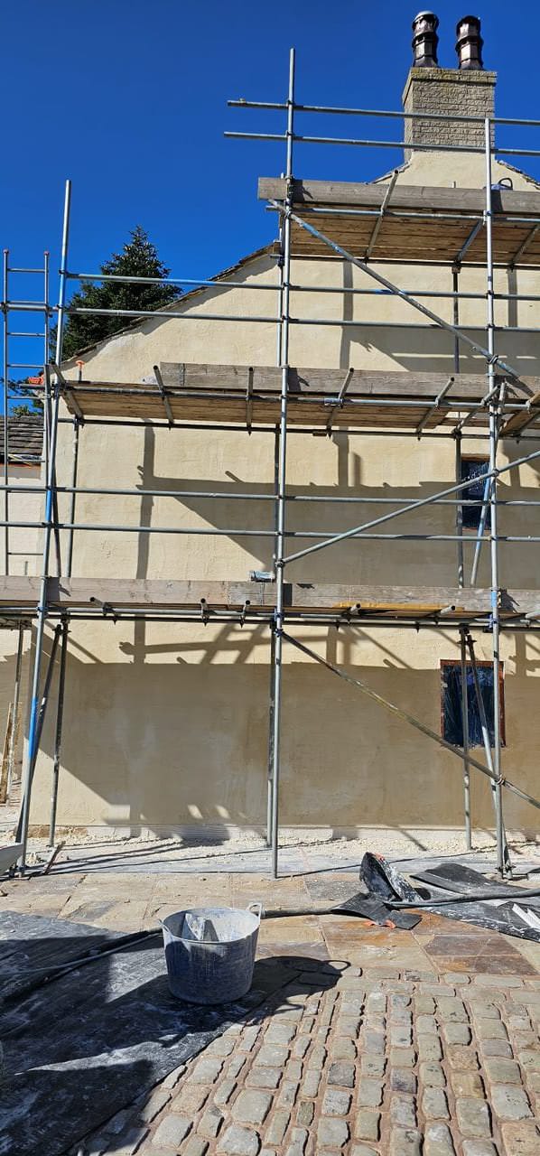 Thin coat render application on home in Preston